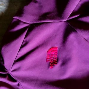 The North Face burgundy , hooded zip up jacket with fleece lining